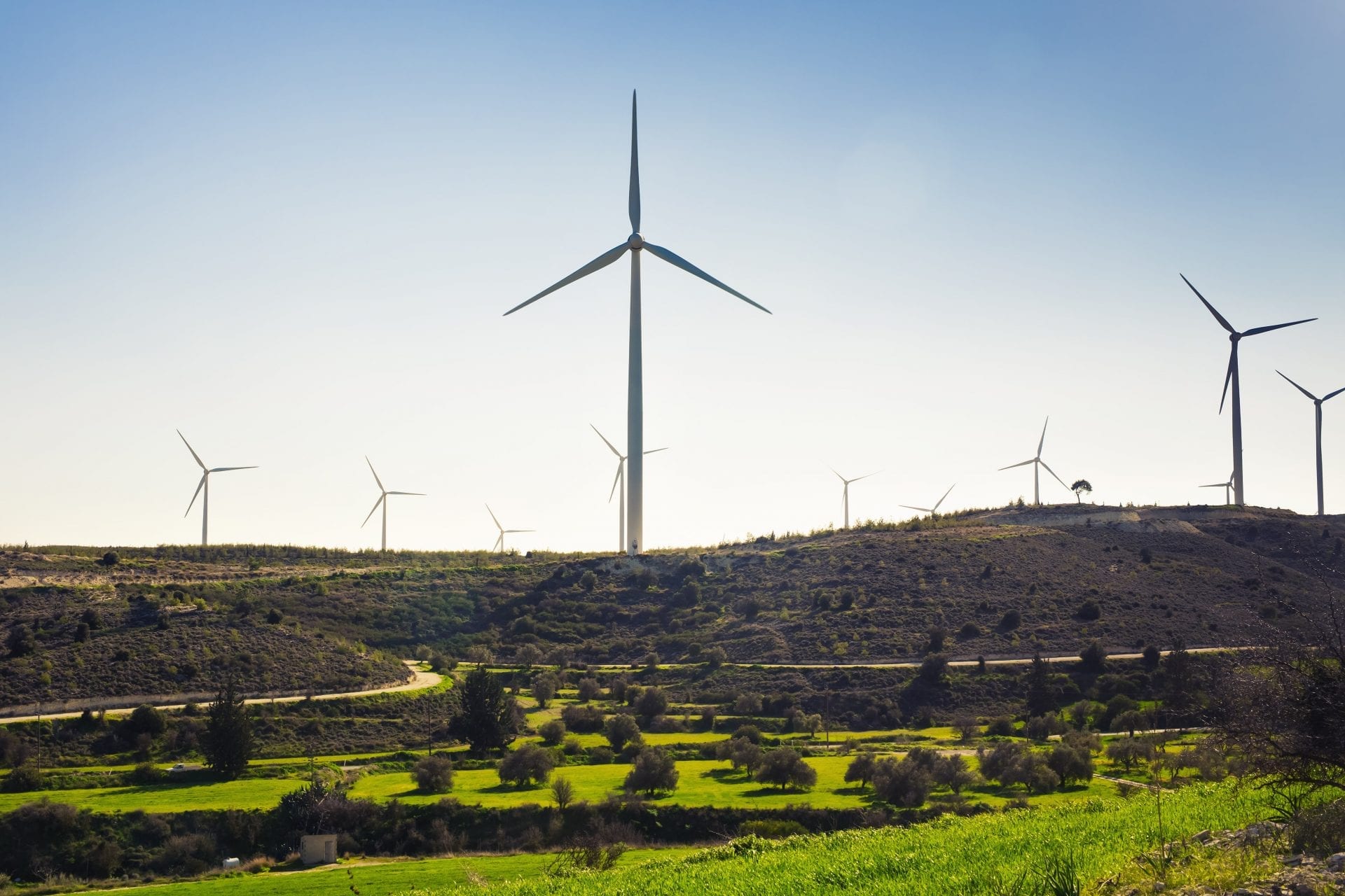 green-meadow-with-wind-turbines-generating-PS79W2B-min