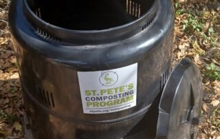 Black compost bin. Label reads St. Pete's Composting Program.